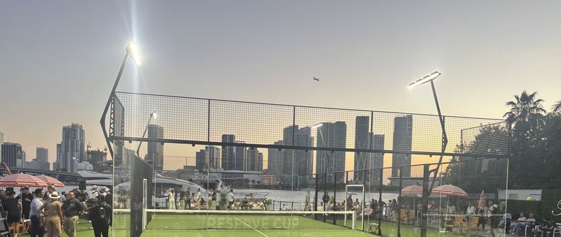 A padel show court at sunset, with the Miami skyline behind it