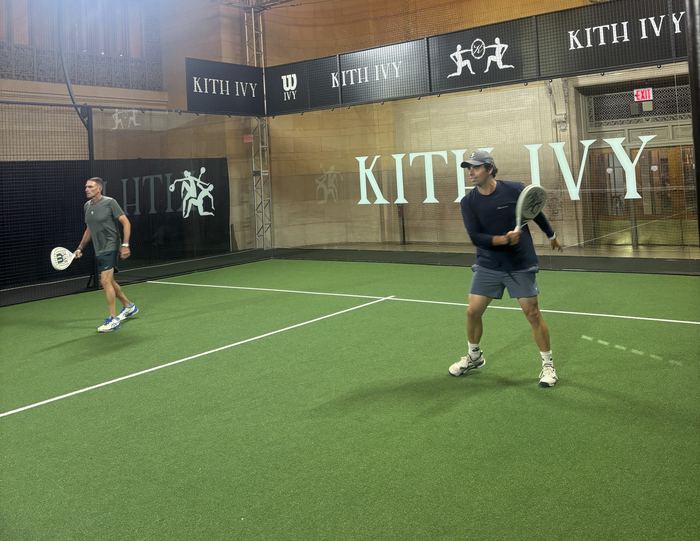 Santi playing a forehand on an indoor padel court